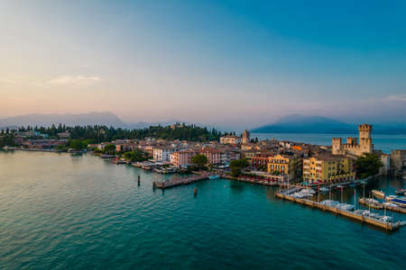 Aerial panoramic view of Sirmione city old town on lake Garda in Lombardy, Italy. Evening photo with a castle in a centerの写真素材