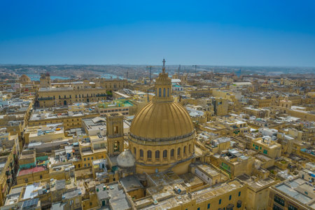 Aerial view of Basilica Lady of Mount Carmel church, St. Pauls Cathedral in the old town of Valetta, Malta. Roofs of Malta capital from above on a sunny dayの写真素材