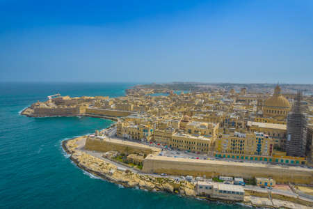 Aerial view of Basilica Lady of Mount Carmel church, St. Pauls Cathedral in the old town of Valetta, Malta. Roofs of Malta capital from above on a sunny dayの写真素材