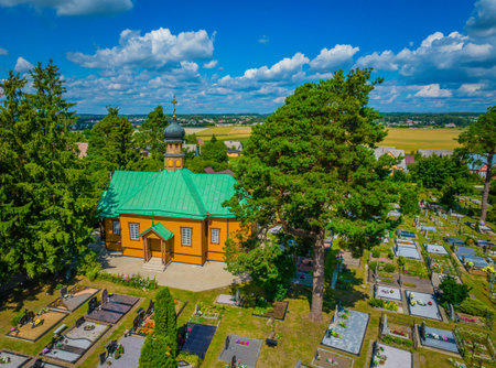Saint Nicholas Orthodox Church in middle of cemetery, Rudamina, Lithuania. Aerial viewの写真素材