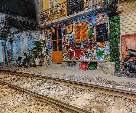Hanoi, Vietnam - 04 30 2023: Hanoi train street in Vietnam at night. A narrow street of the Hanoi...