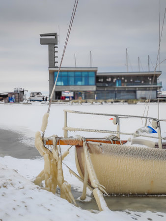 Spectacular ice formations on a boat cold and windy day. Natural phenomenon. Frozen ship in Nida port in Curonian spit, Lithuaniaの写真素材