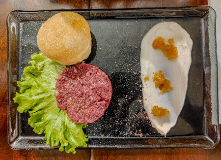 Horse meat tartare. A beautifully served dish with salad leave, special sauce and bread. Italian kitchen foodの写真素材