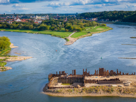 Construction site of new modern bridge construction in Kaunas, Lithuania. Aerial drone view of bridge connecting two shores of a river. Work progressの写真素材