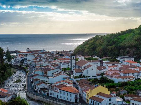 Povoacao, Sao Miguel Island, Azores. Aerial drone view of Azorean town with a town hall, church, and stunning ocean and mountain views.の写真素材
