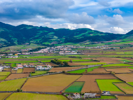Sao Miguel Island scenic landscape with mountains and cultivated land in Azores, Portugal. Aerial drone view of panoramic Acores islandの写真素材