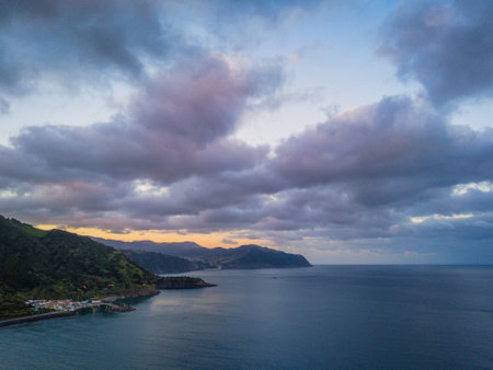 Aerial drone view of Ribeira Quente and Praia do Fogo with volcanic black sand beach. Landscape of Sao Miguel coastline with green mountains in Azoresの写真素材
