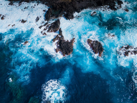 Rocks, cliffs, waves and turquoise water in Atlantic ocean, Mosteiros, Azores islands. Aerial drone view of Acores archipelagoの写真素材