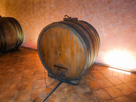 Old wine barrel in the a wine cellar. Wine vault in an Italian winery with a different years...
