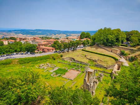 Volterra, Tuscany. The Roman theatre ruins in Volterra, medieval Tuscan town located on a hill with old town, old houses, and towers in Italyの写真素材
