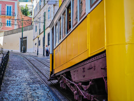 Gloria Funicular in Lisbon. Tram with a wood brass interior climbing a steep hill to Miradouro de Sao Pedro de Alcantaraの写真素材