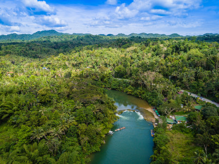 Loboc River with small waterfall and river threshold in Bohol island, Philippines. Aerial drone view of river popular for river cruisesの写真素材