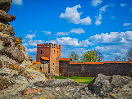 Medininkai castle tower in background of defensive stone wall ruins in Medininkai, Lithuania