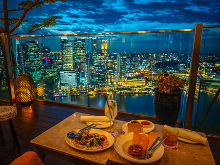 Luxury dinner at Singapore with a view to Marina bay and Singapore skyline. Skyscraper skybar...