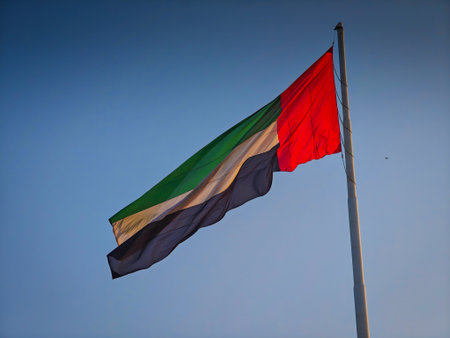 11 30 2025 - Abu Dhabi, UAE. Giant flag of the United Arab Emirates fluttering in the windのeditorial素材