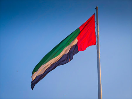 11 30 2025 - Abu Dhabi, UAE. Giant flag of the United Arab Emirates fluttering in the windのeditorial素材