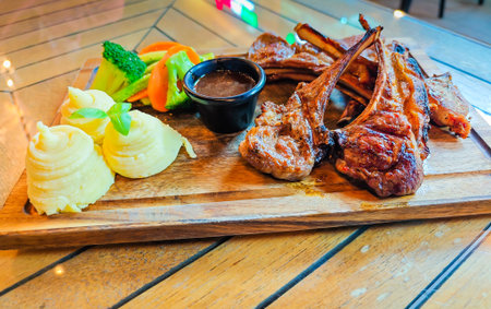 Grilled lamb ribs with garnish, gourmet restaurant dish, fine dining, culinary presentation, close up food photographyの写真素材