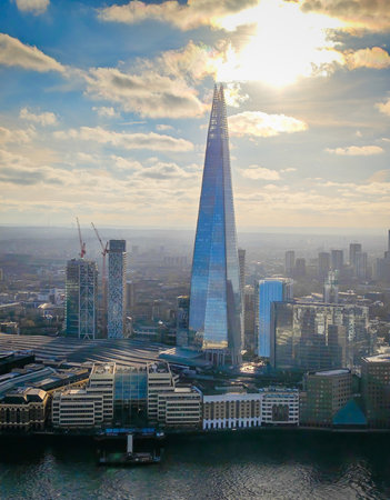 Aerial drone view of The Shard in London skyline - iconic skyscraper rising above the city panorama. Dramatic London landscapeの写真素材