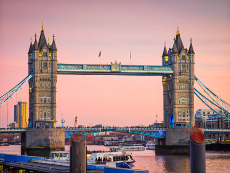 04 08 2026 - London, UK. Tower Bridge in London at red sunset, iconic landmark over Thames River, dramatic sky, historic architecture