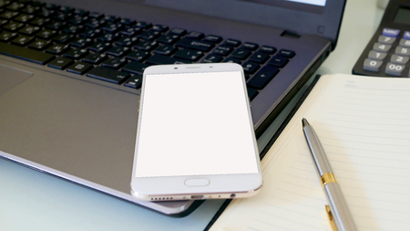 Business man using a mobile phone device with stock graph,checking market dataの写真素材
