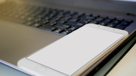 Business man using a mobile phone device with stock graph,checking market dataの写真素材