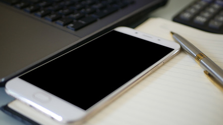 Business man using a mobile phone device with stock graph,checking market dataの写真素材