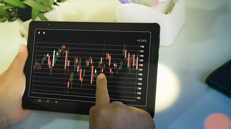 Businessman checking stock market dataà¸¡Stock Market Application for Mobile, Analyzing Data...