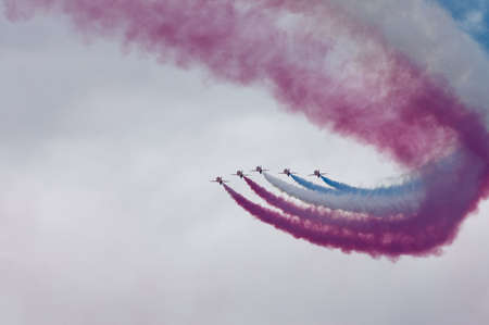 red arrows formation with Union Jack colours in smoke trailの写真素材