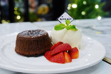 Chocolate lava with strawberry and vanilla ice-creamの写真素材