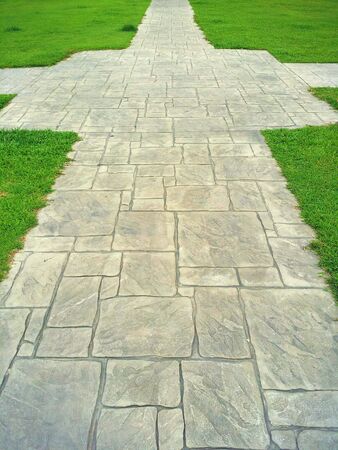 Stone path on grass field.の素材
