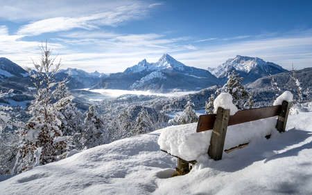 Rest area with a great view over the snowy Berchtesgaden, Bavaria, Germanyの写真素材