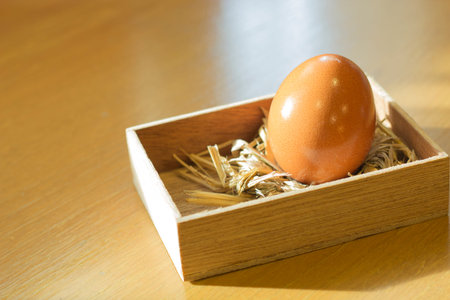 Hen s egg in the wooden box on wooden floor