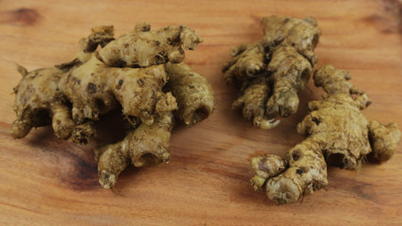 Fresh ginger rhizome on wooden table