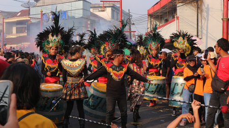 Street dancing parade of colorful mask and costume during the celebration of Indonesian independence...