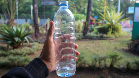 Woman's hands holding empty plastic bottles- close-up