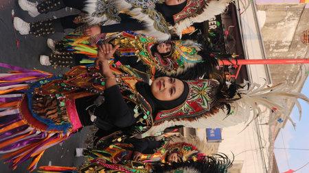 Street dancing parade of colorful mask and costume during the celebration of Indonesian independence...
