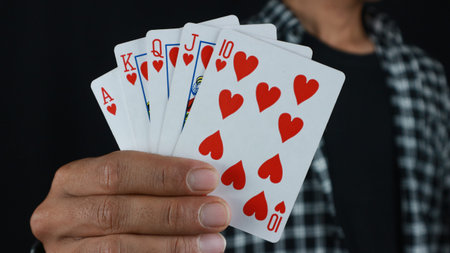 Gambling concept. Close up of Poker Player male hand Winning Royal Flush , gambling club. Ð¡asino...