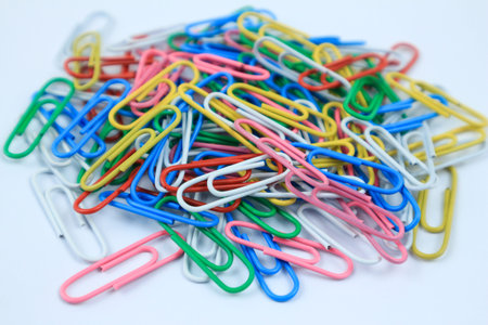 Colorful paper clips set on white background.の写真素材