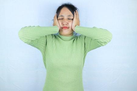 Asian woman suffering from headache because pain and migraine. Hands on head.の写真素材