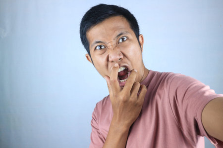 Disbelief, shocked facial expression of young asian man looking at camera. isolated on white...