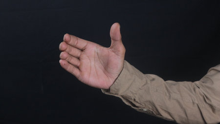 Close up male hand isolated on black backgroundの写真素材