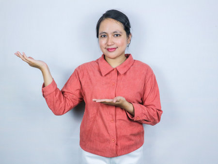 Beautiful smiling asian businesswoman presenting productの写真素材