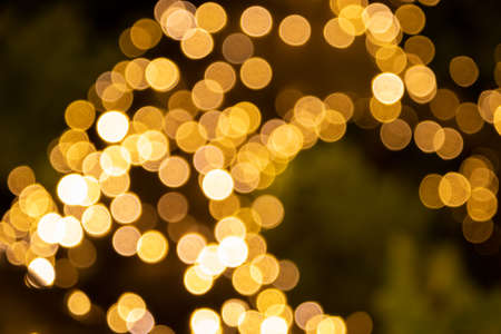 Background bokeh of sparkling golden party lights for festive or holiday themed concepts with copy spaceの写真素材