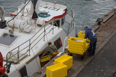 SEPTEMBER 2021 - GUILVINEC - FRANCE: view on fisherman unloading their fish on the harbor of the guivilnec in Brittanyのeditorial素材