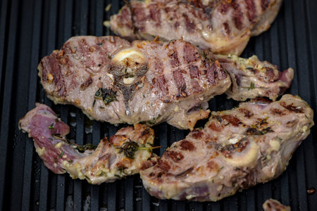 view of lamb being cooked on a grill in outdoorの写真素材
