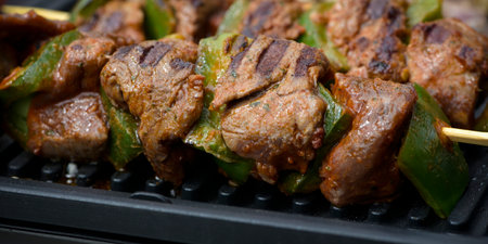 view of beef being cooked on a griddle in outdoorの写真素材