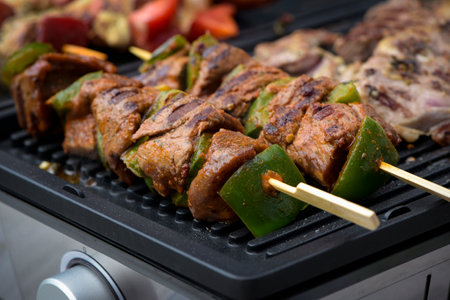 view of beef being cooked on a griddle in outdoorの写真素材
