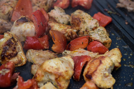 view of chicken being cooked on a grill in outdoorの写真素材