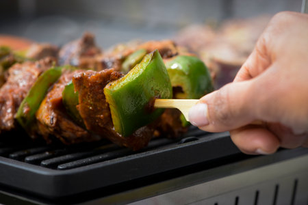 view of beef being cooked on a griddle in outdoorの写真素材