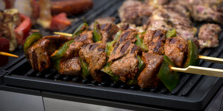 view of beef being cooked on a griddle in outdoorの写真素材
